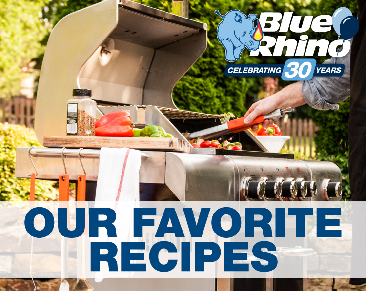 Man standing behind grill, grilling food.